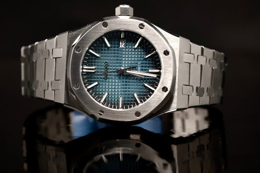 Close-up of a luxury watch with a blue textured dial and stainless steel bracelet, reflecting light elegantly.