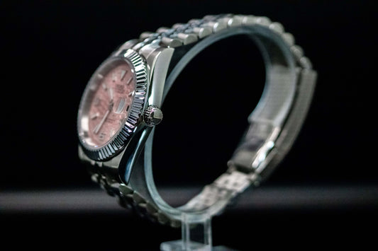 Side view of Seiko Mod Pink Land Dweller watch featuring a pink dial and stainless steel case.