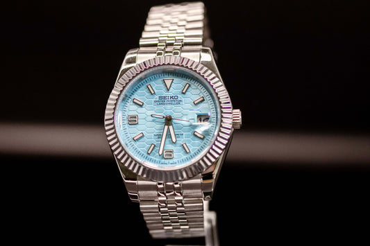 Ice Blue Dial Seiko Mod Land Dweller watch with brushed metal case and bracelet, showcasing modern design and durability.
