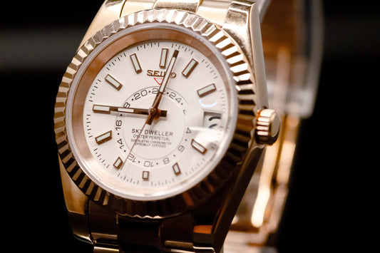 Rose Gold Seiko Mod Sky-Dweller watch featuring white dial and fluted bezel, luxury affordable timepiece.