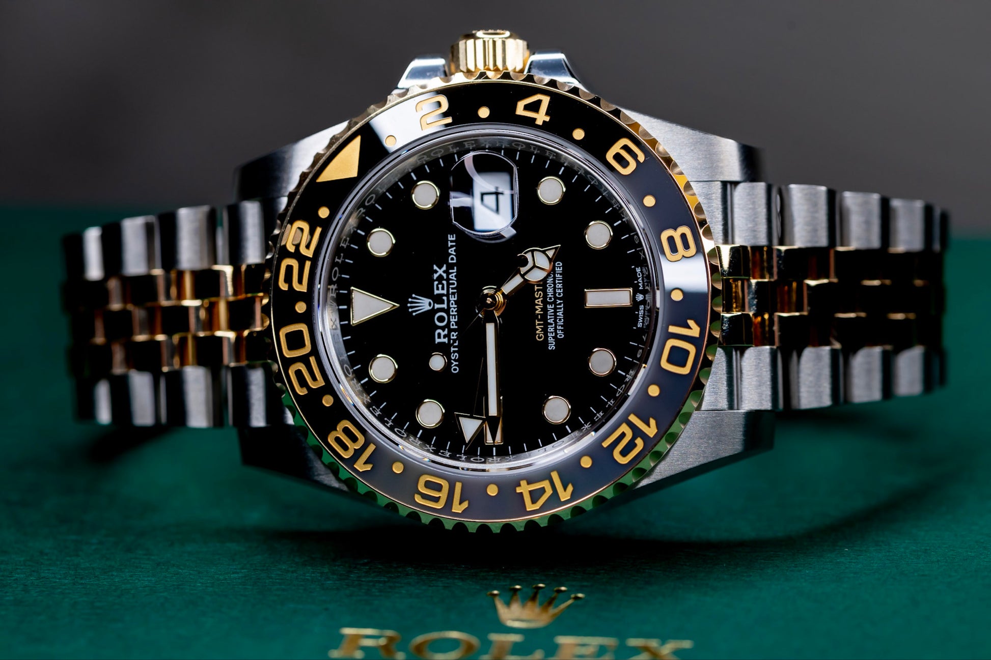 2026 Rolex GMT-Master II Zombie displayed on a green Rolex box, showcasing its striking black dial and gold accents.