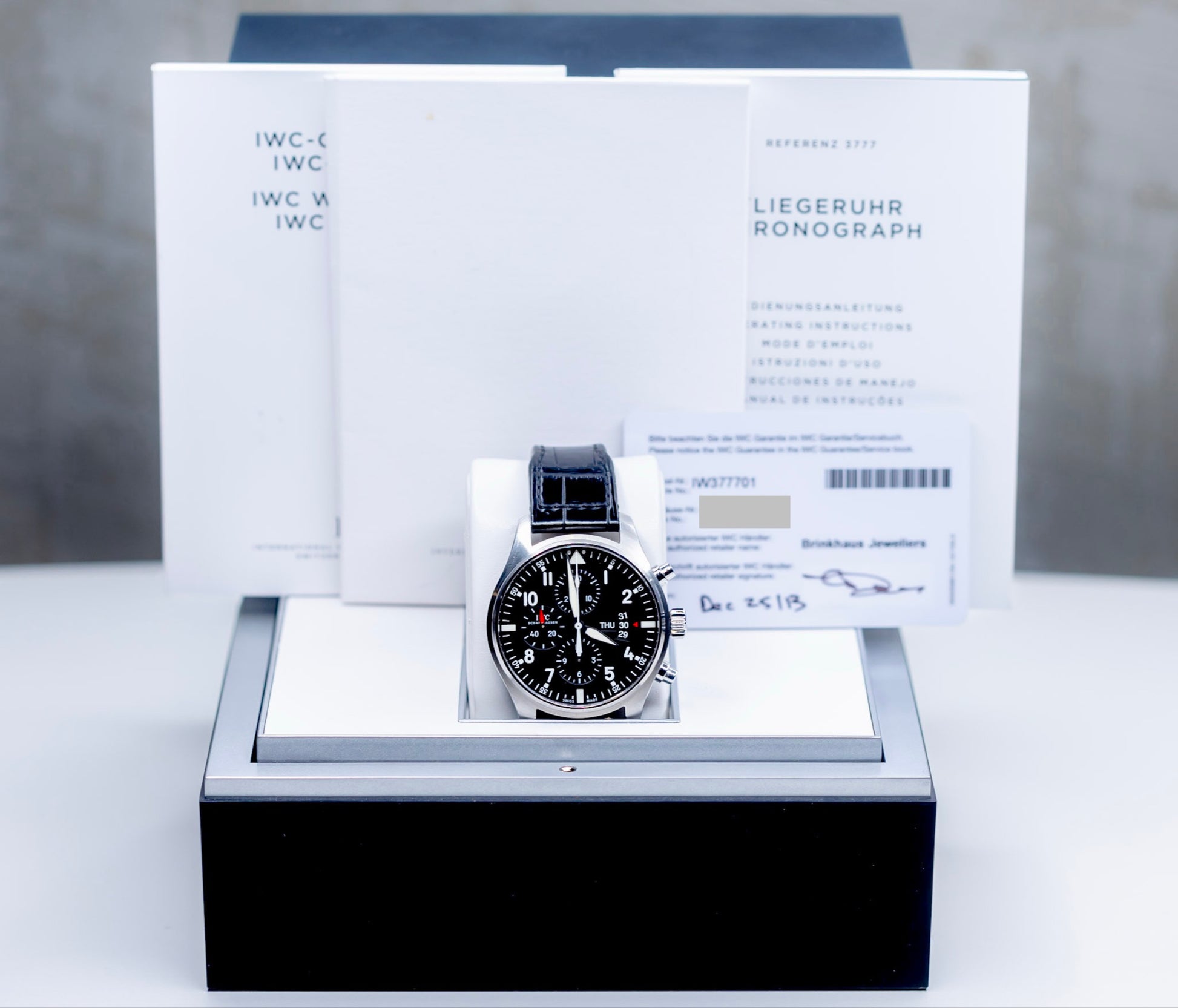 IWC Pilots Watch Chronograph with original box and papers displayed elegantly.
