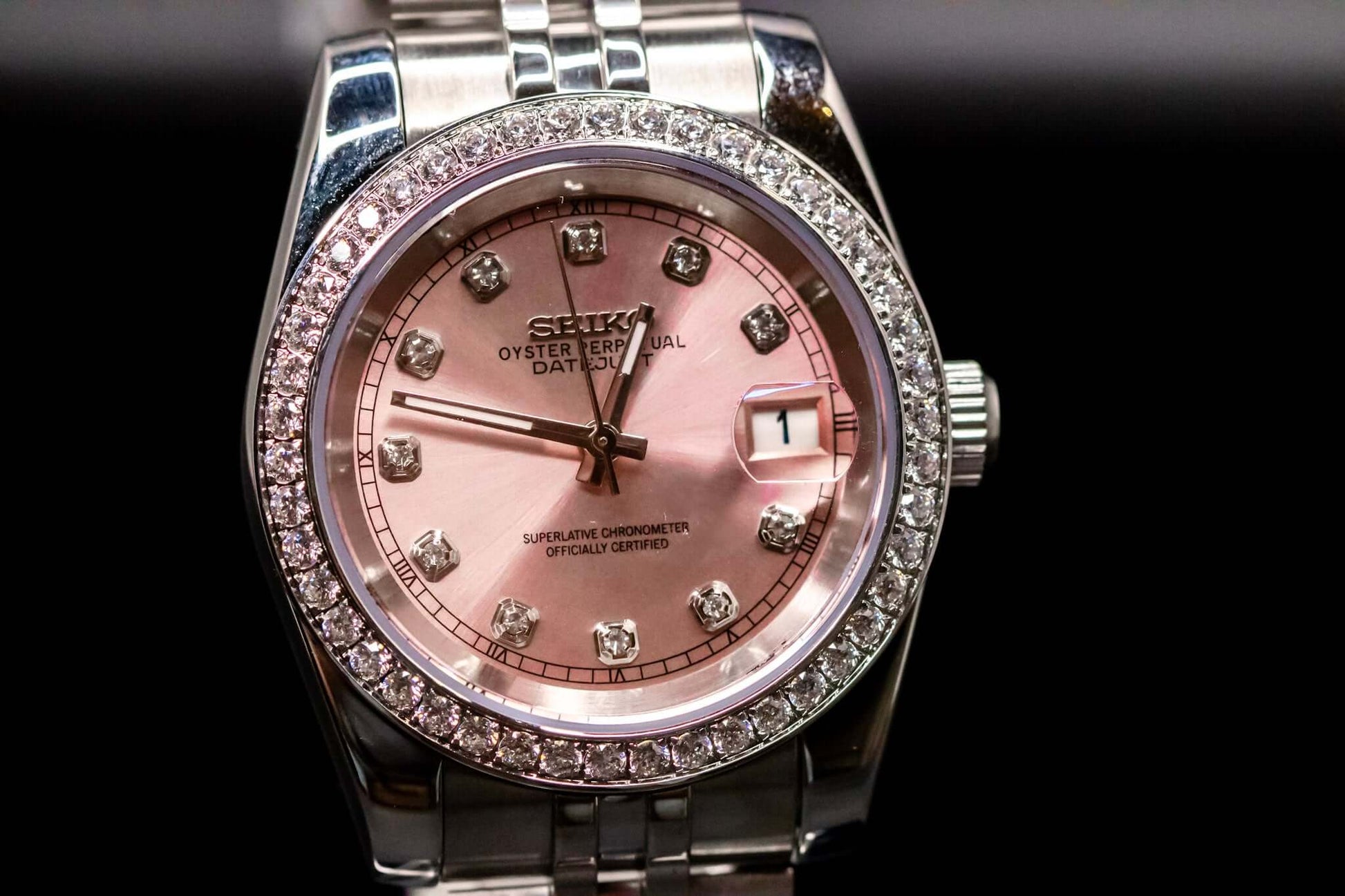 Pink Diamond Bezel Seikomod DateJust watch featuring a pink dial and diamond markers, luxury timepiece by Custom Seiko Mods.