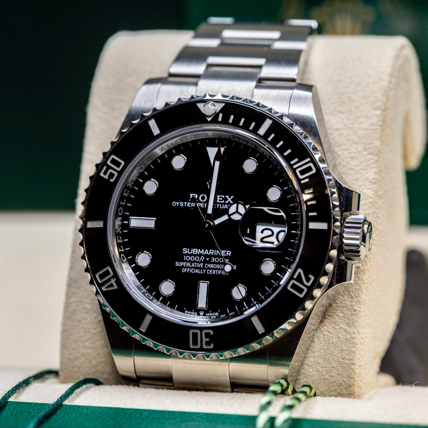 2025 Rolex Submariner Date black watch displayed on a soft cushion, showcasing its iconic black dial and bezel.