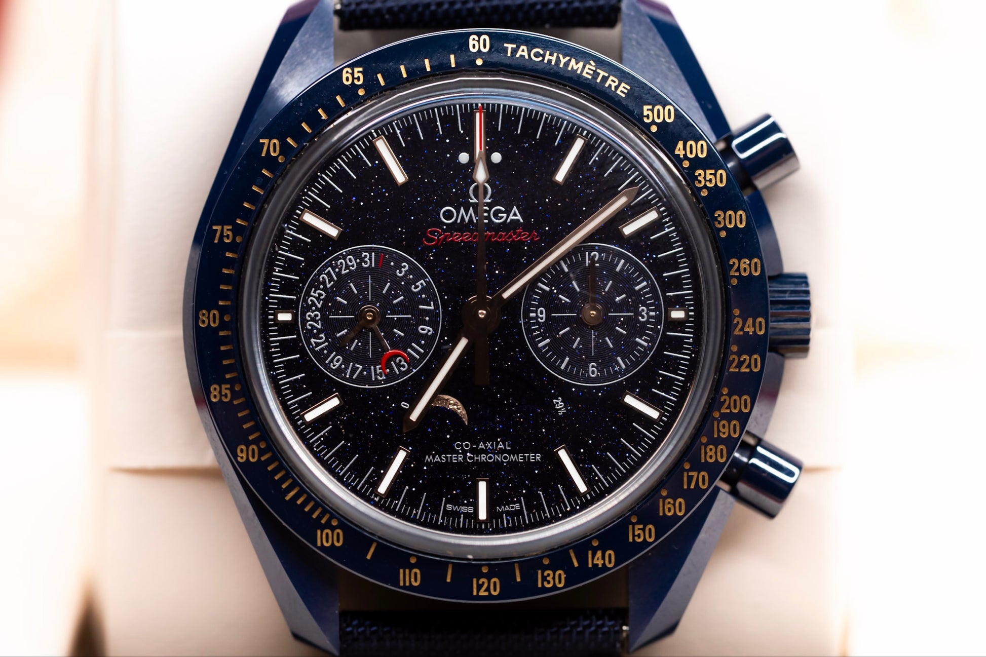 Close-up of the Omega Speedmaster Blue Side of the Moon watch showcasing its starry dial and moonphase display.