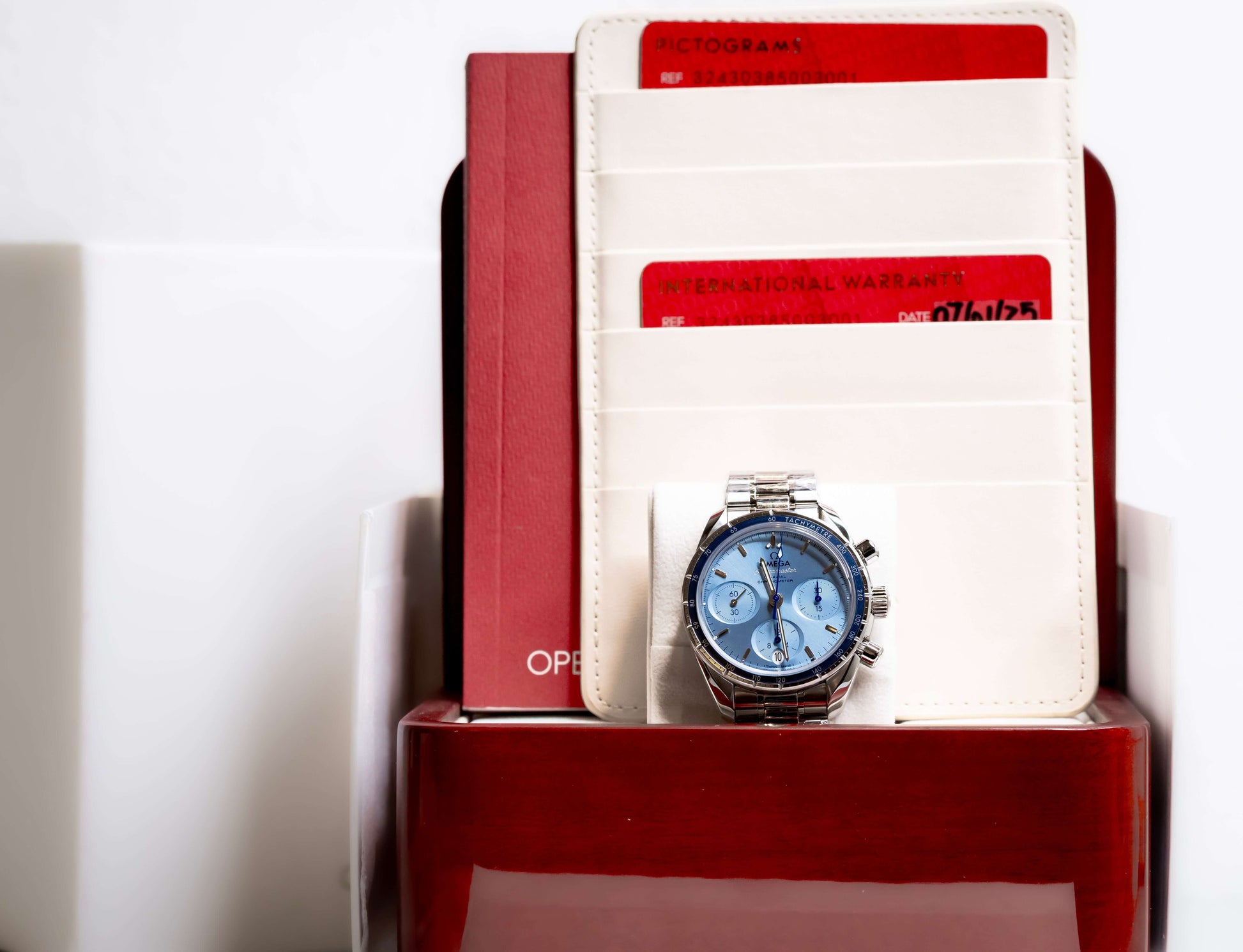 2025 OMG Speedmaster 38 Blue Dial Chronograph 324.30.38.50.03.001 – Full Set displayed with warranty cards.