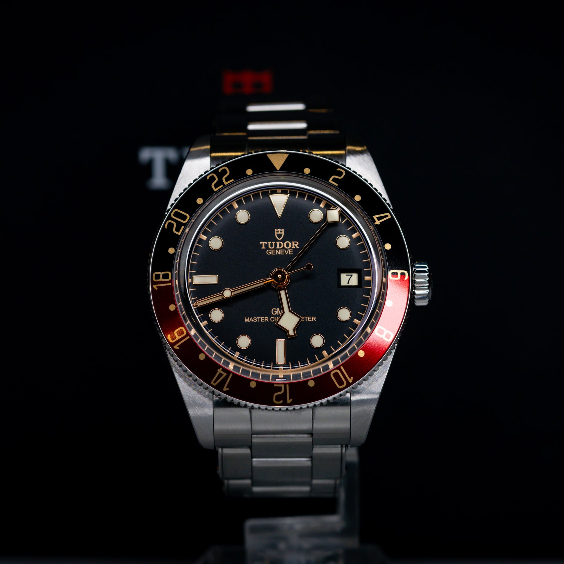 Tudor Black Bay 58 GMT Coke watch with a black dial and silver bracelet, showcasing the automatic movement and GMT features.