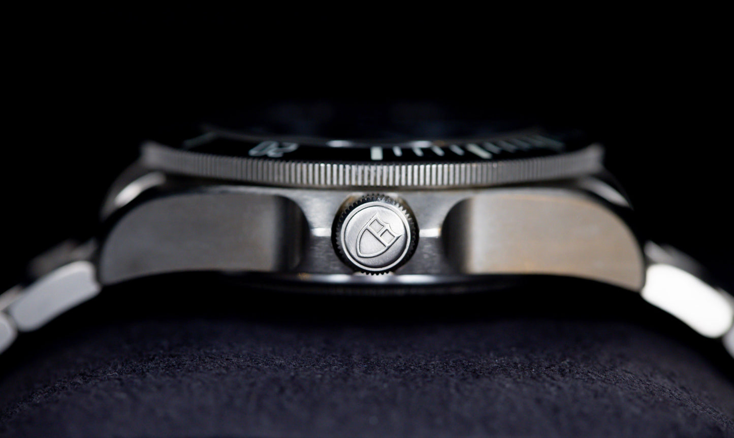 Tudor Pelagos dive watch close-up showcasing the crown and titanium case design.
