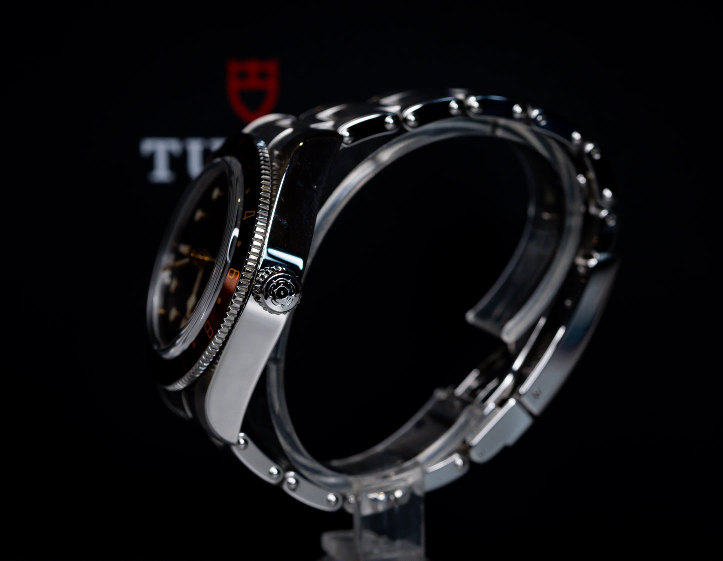 Tudor Black Bay 58 GMT Coke watch showcased from the side, highlighting the black dial and steel bracelet.