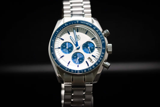 KWC Snoopy Chronograph watch with white dial and blue accents in stainless steel case on a black background.