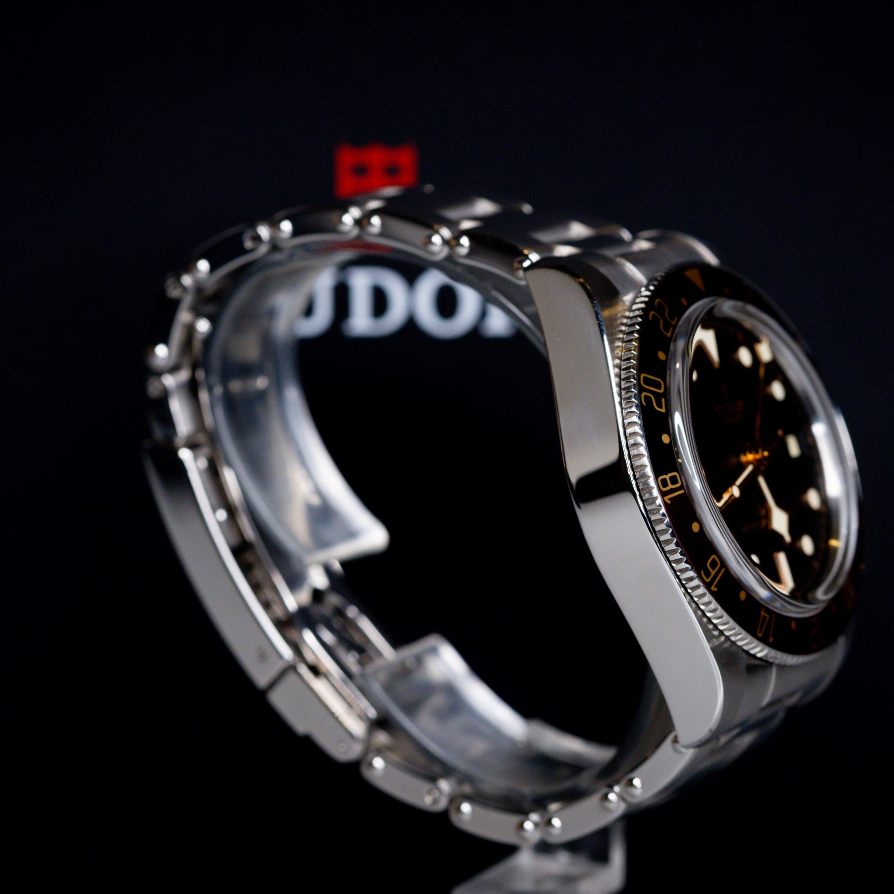 Tudor Black Bay 58 GMT Coke watch side view showcasing stainless steel case and black dial.