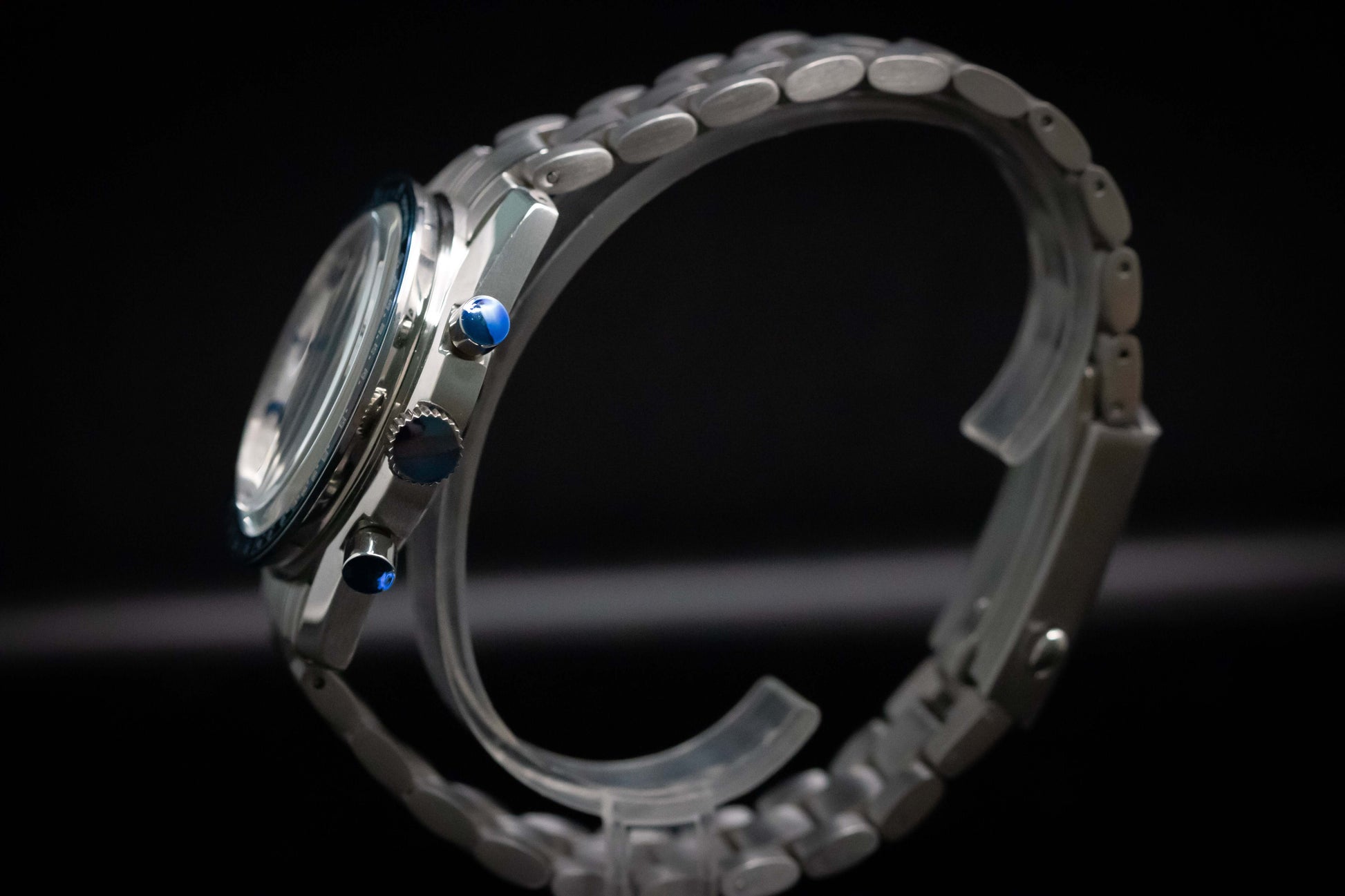 KWC Snoopy Chronograph watch showcasing its blue pushers and stainless steel bracelet