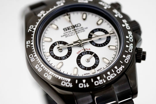 SeikoMod Panda Daytona watch with black PVD case, white dial, and black subdials, showcasing elegance and precision.
