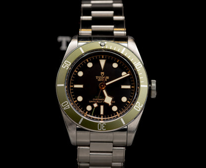 Tudor Black Bay Harrods Edition 41mm watch with green bezel and stainless steel bracelet.