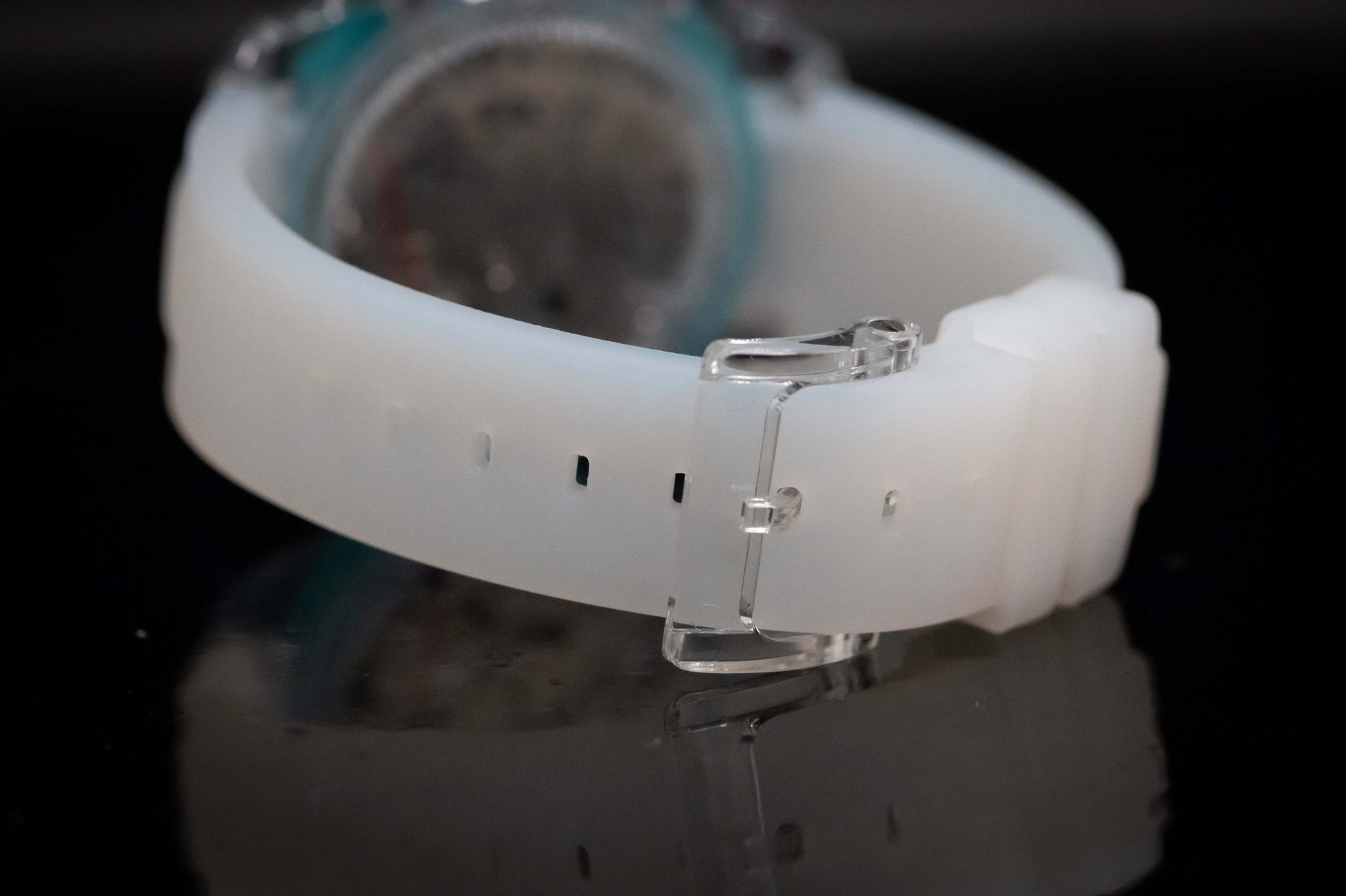 Close-up of the KWC Ice Ceramic Chronograph's white silicone strap with a sturdy buckle.