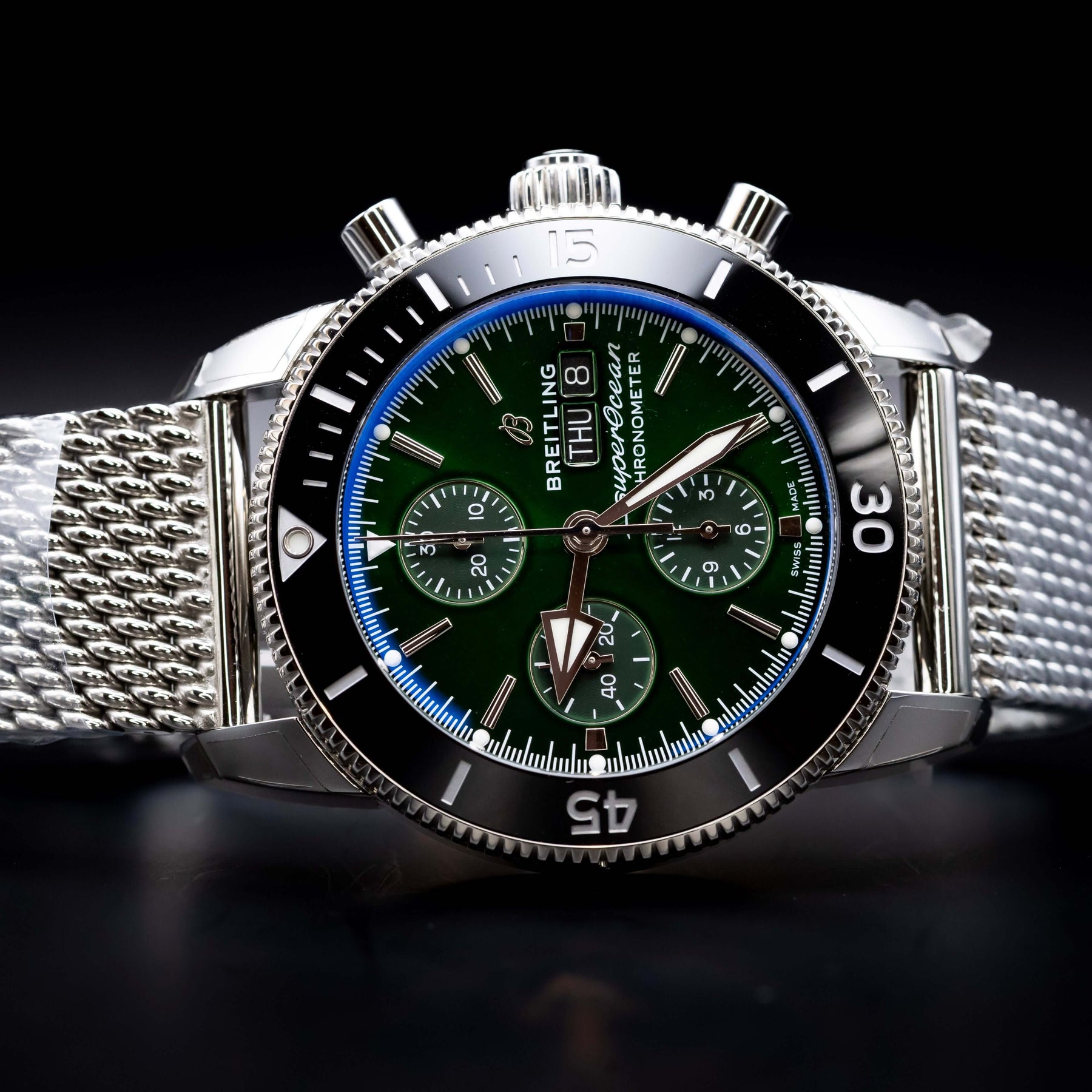 2025 BNIB - Breitling SuperOcean Chronograph Green 44mm- Breitling A13313 displayed on a textured silver bracelet.