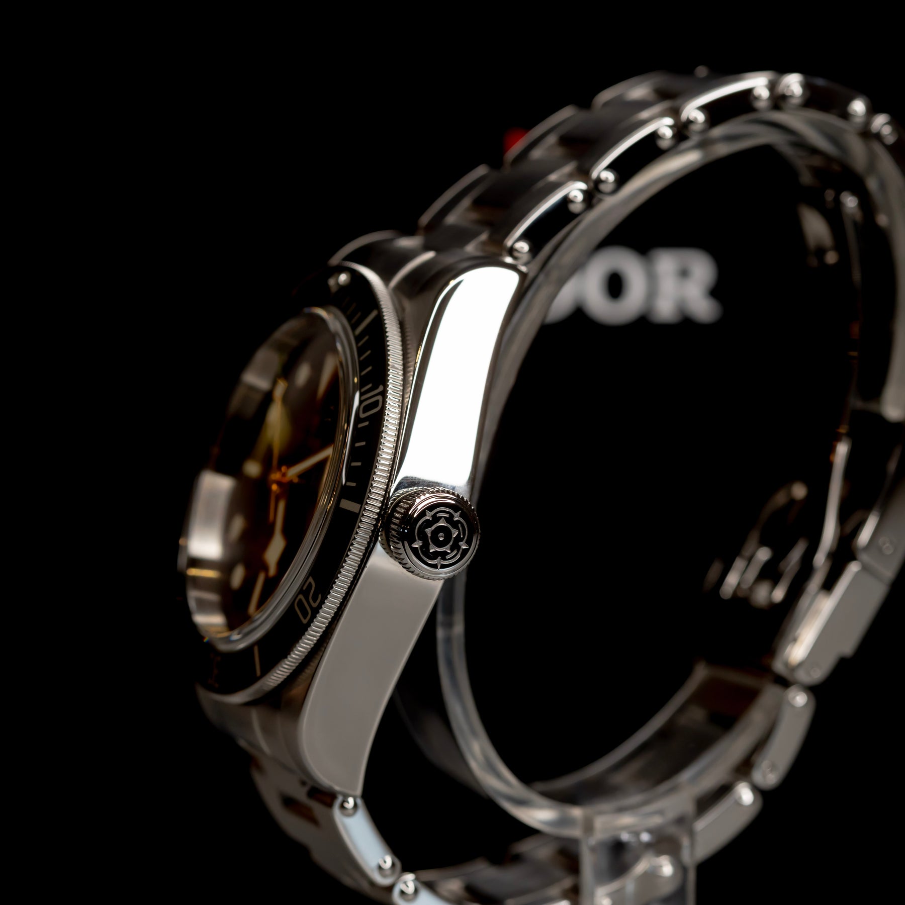 Tudor Black Bay Harrods Edition 41mm watch side view showcasing stainless steel and green bezel details.