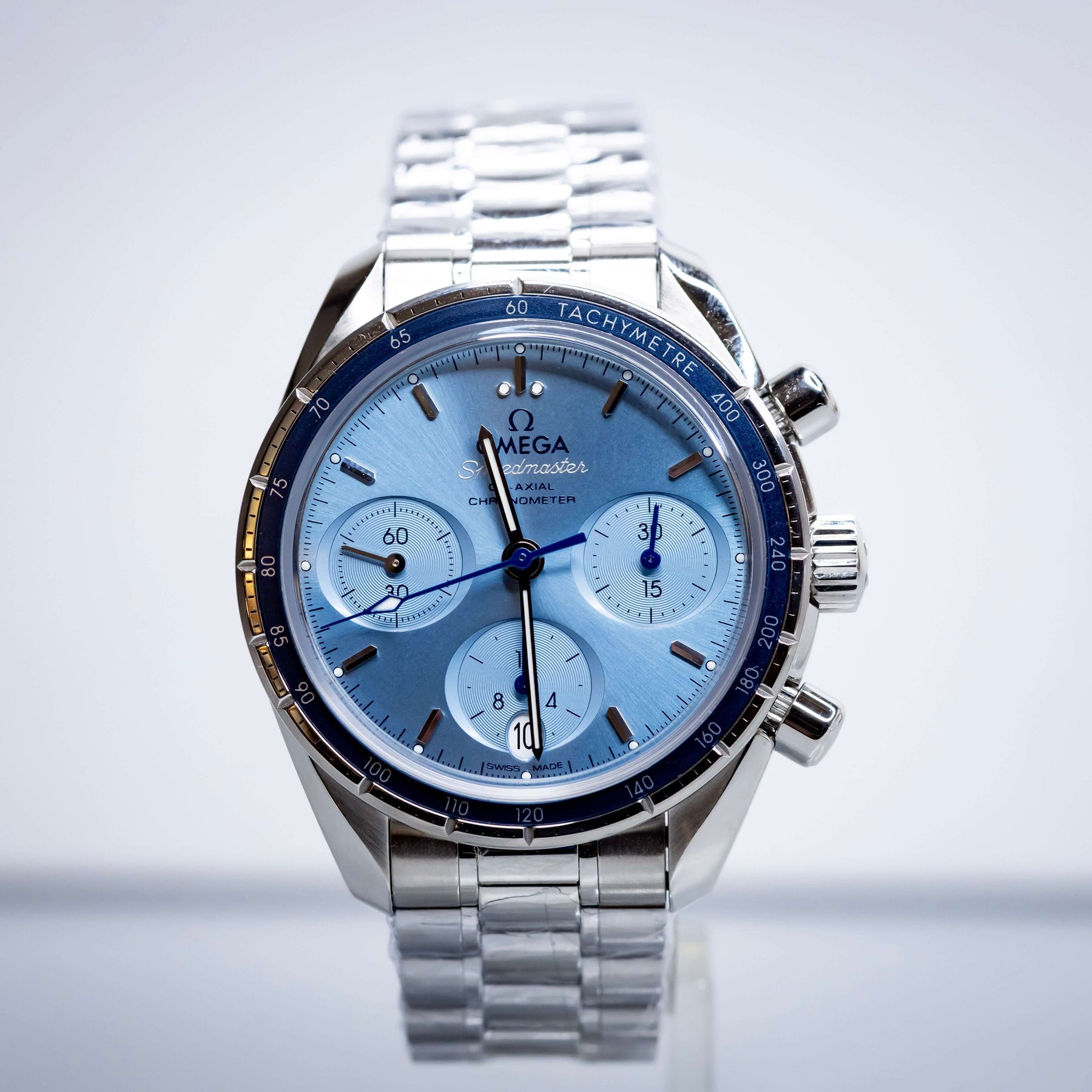 2025 OMG Speedmaster 38 Blue Dial Chronograph 324.30.38.50.03.001 – Full Set displayed on a stainless steel bracelet.