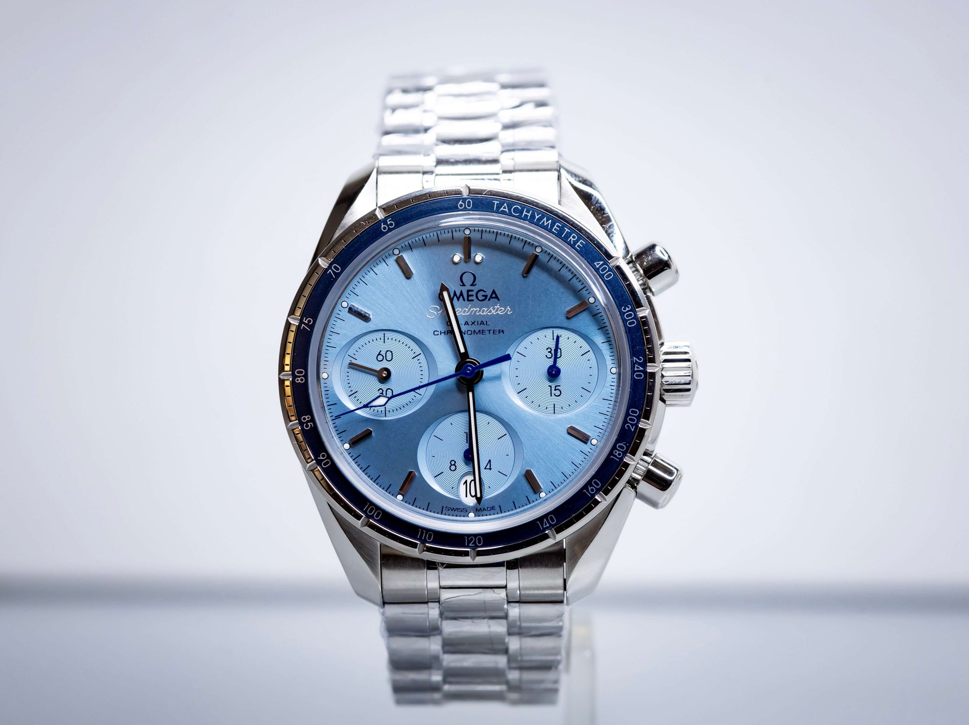2025 OMG Speedmaster 38 Blue Dial Chronograph 324.30.38.50.03.001 – Full Set displayed on a stainless steel bracelet.