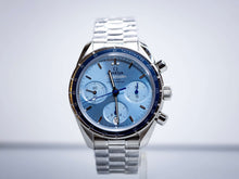 2025 OMG Speedmaster 38 Blue Dial Chronograph 324.30.38.50.03.001 – Full Set displayed on a stainless steel bracelet.