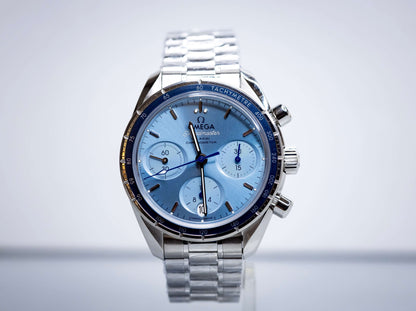 2025 OMG Speedmaster 38 Blue Dial Chronograph 324.30.38.50.03.001 – Full Set displayed on a stainless steel bracelet.