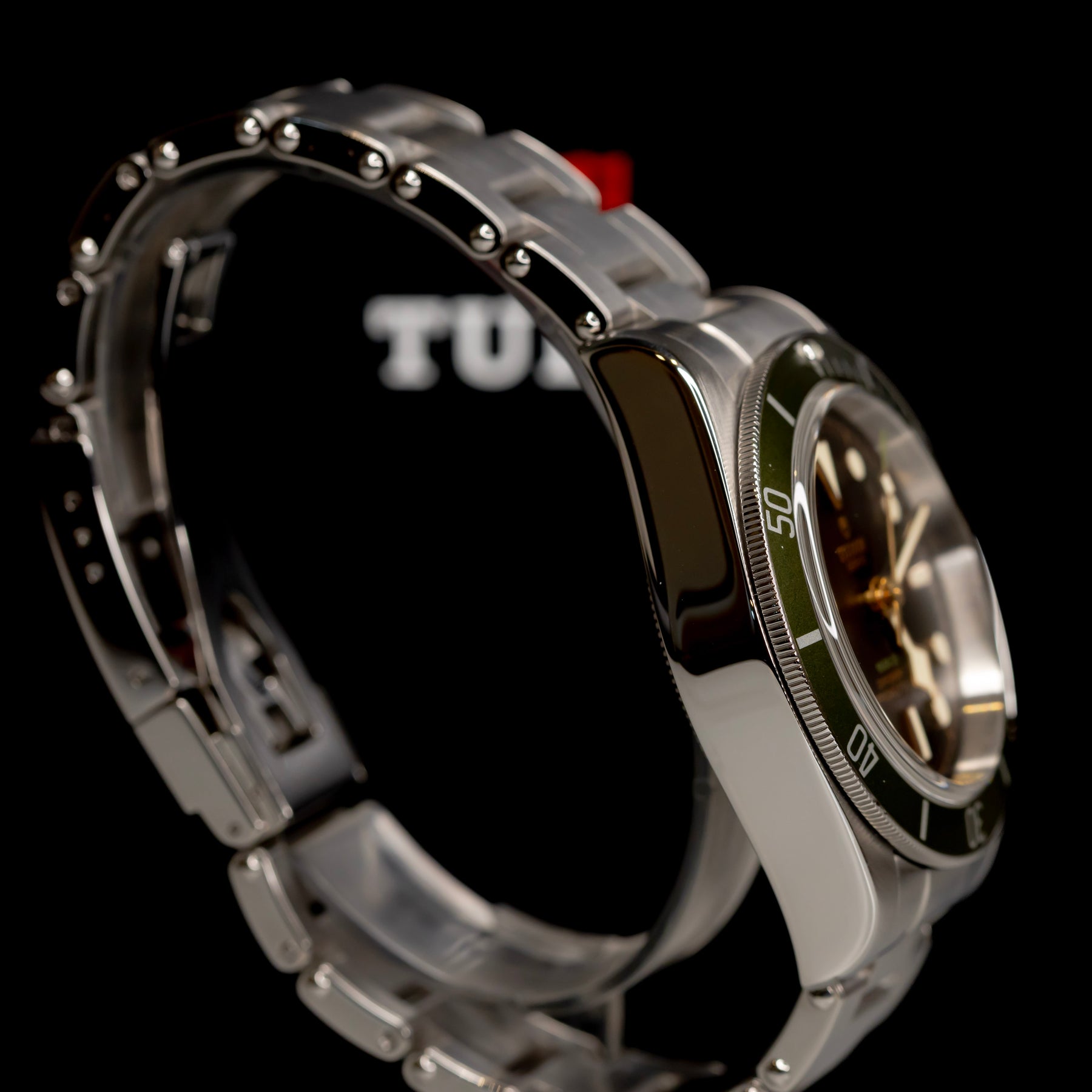 Tudor Black Bay Harrods Edition 41mm watch with green bezel and stainless steel bracelet.