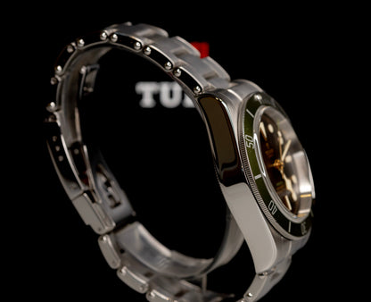 Tudor Black Bay Harrods Edition 41mm watch with green bezel and stainless steel bracelet.