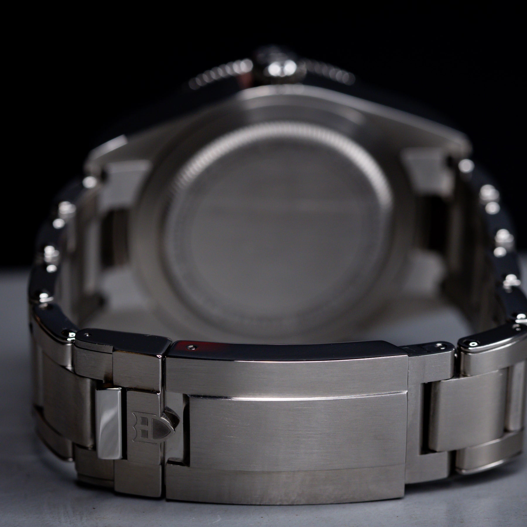 Tudor Black Bay 58 GMT Coke watch back view showing stainless steel bracelet and case details.