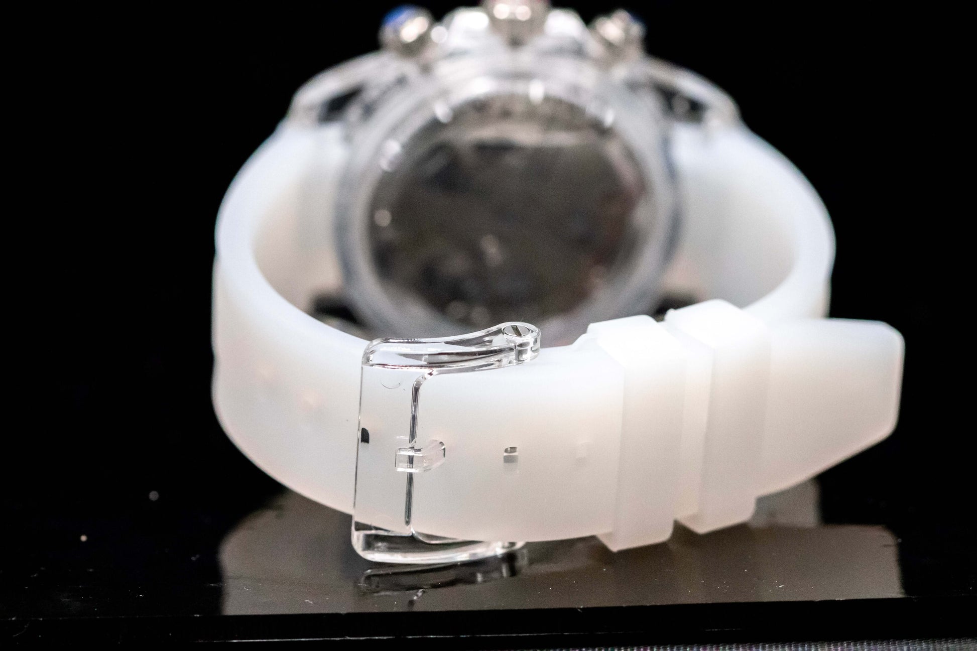 KWC White Ceramic Chronograph watch back view with a sleek white band and polished clasp on a dark background.