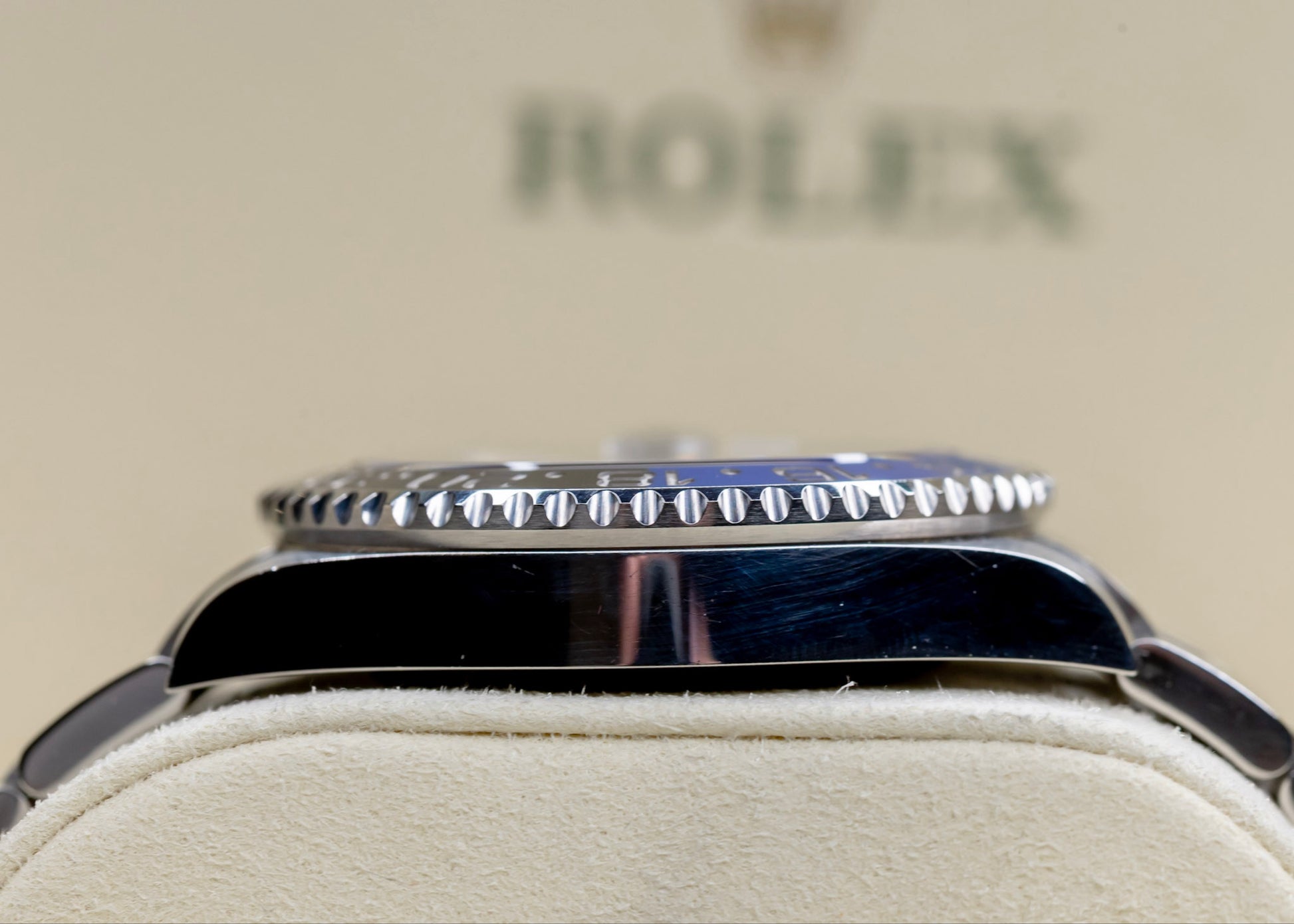2021 Rolex GMT-Master II Batman displayed on a soft surface showcasing its iconic two-tone ceramic bezel.