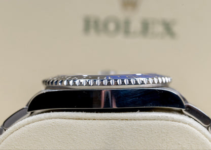 2021 Rolex GMT-Master II Batman displayed on a soft surface showcasing its iconic two-tone ceramic bezel.