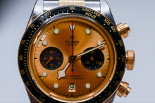 Tudor Black Bay Chrono original box and papers with gold and black dial, chronograph features, and distinctive design.