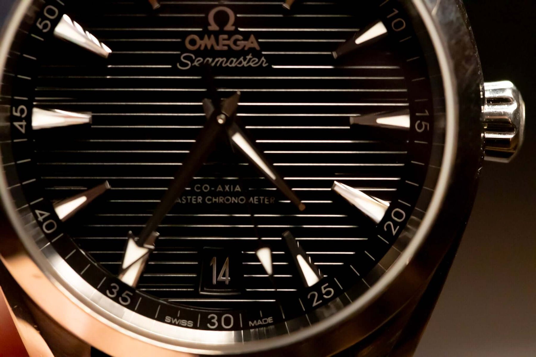 Close-up of the 2022 Omega Seamaster Aqua Terra watch with black teak-pattern dial and stainless steel case.
