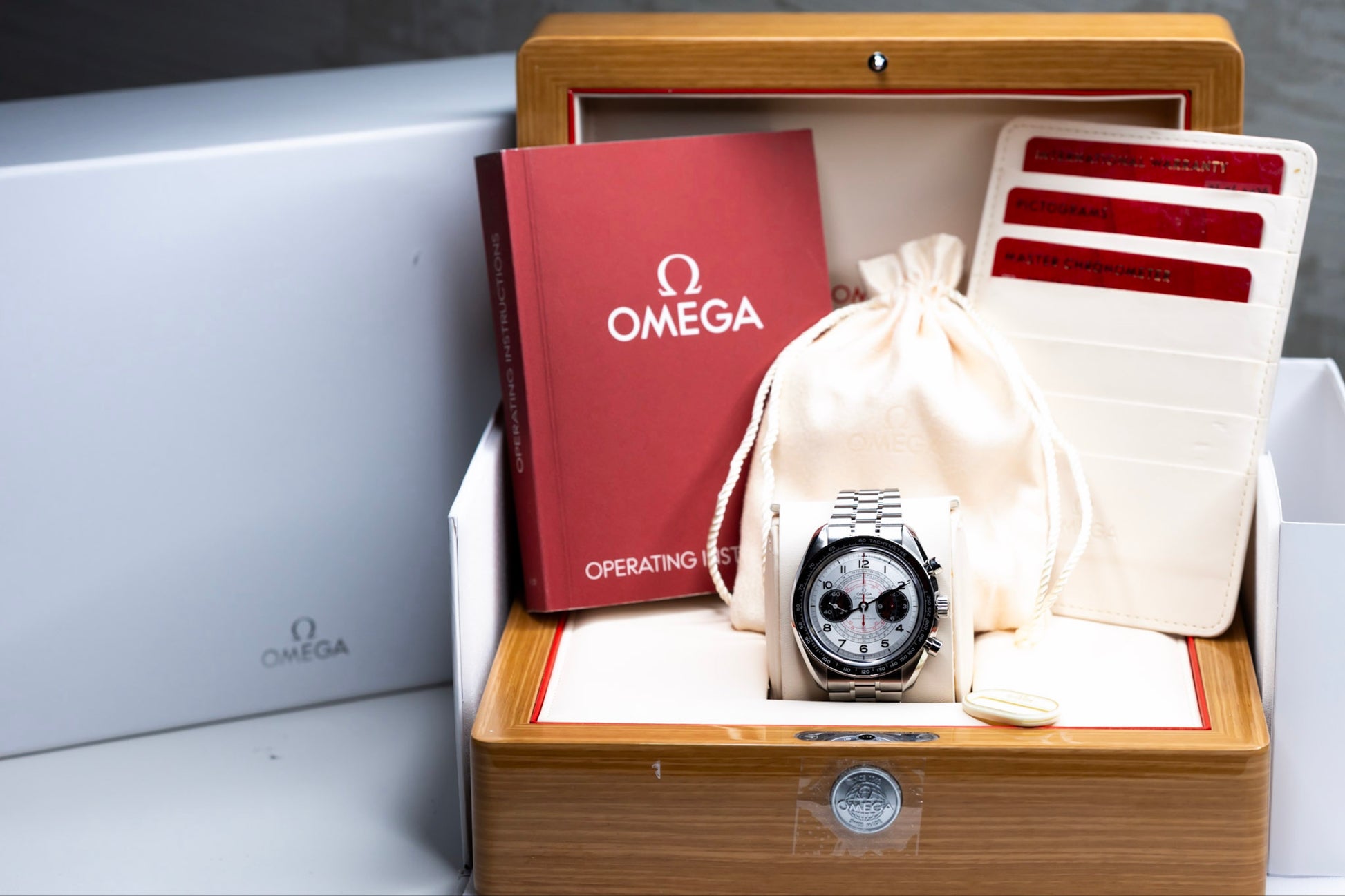 2024 Omega Speedmaster Chronoscope with stainless steel bracelet displayed in luxury packaging.