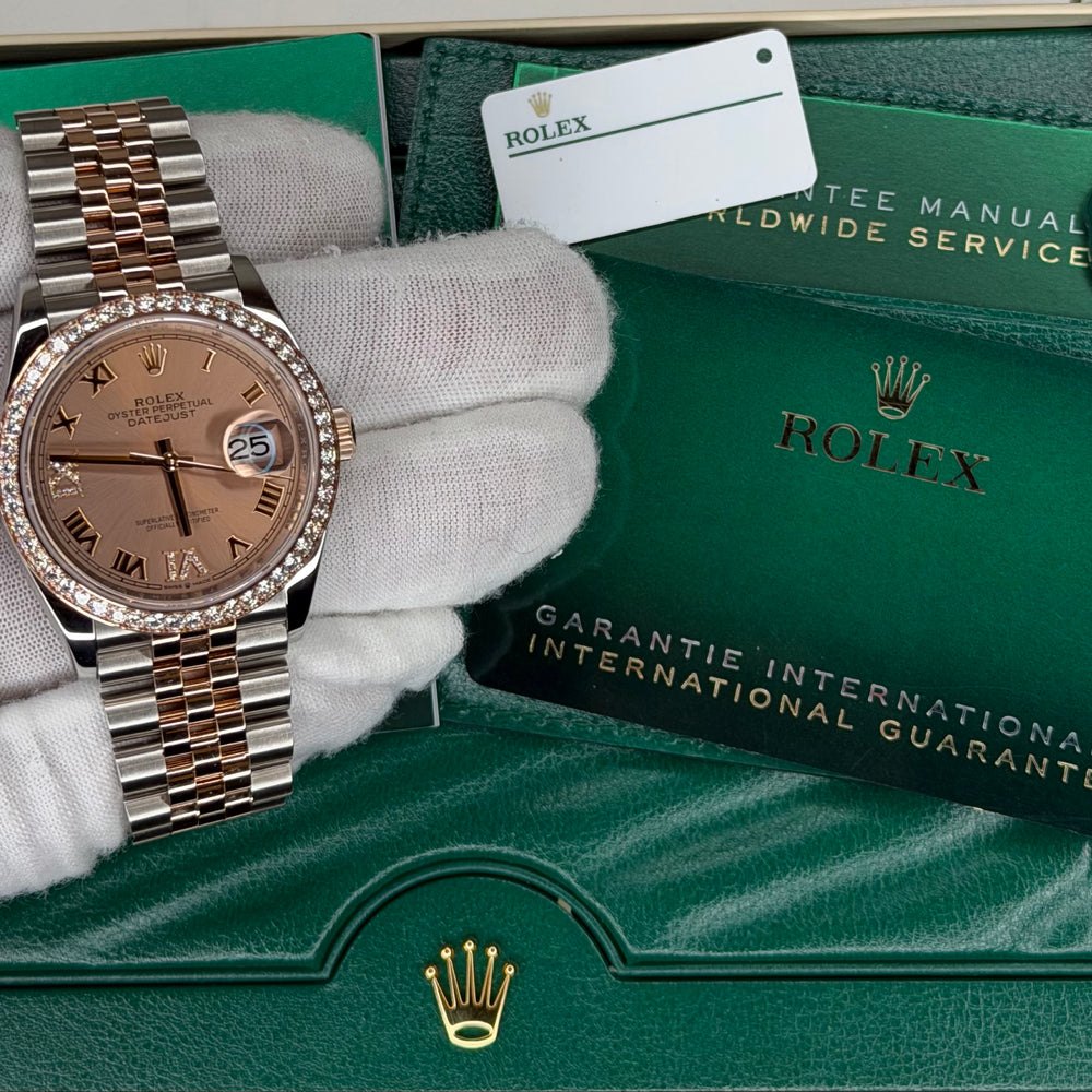 Rolex Datejust 36 watch displayed on a hand with certificate and green packaging.