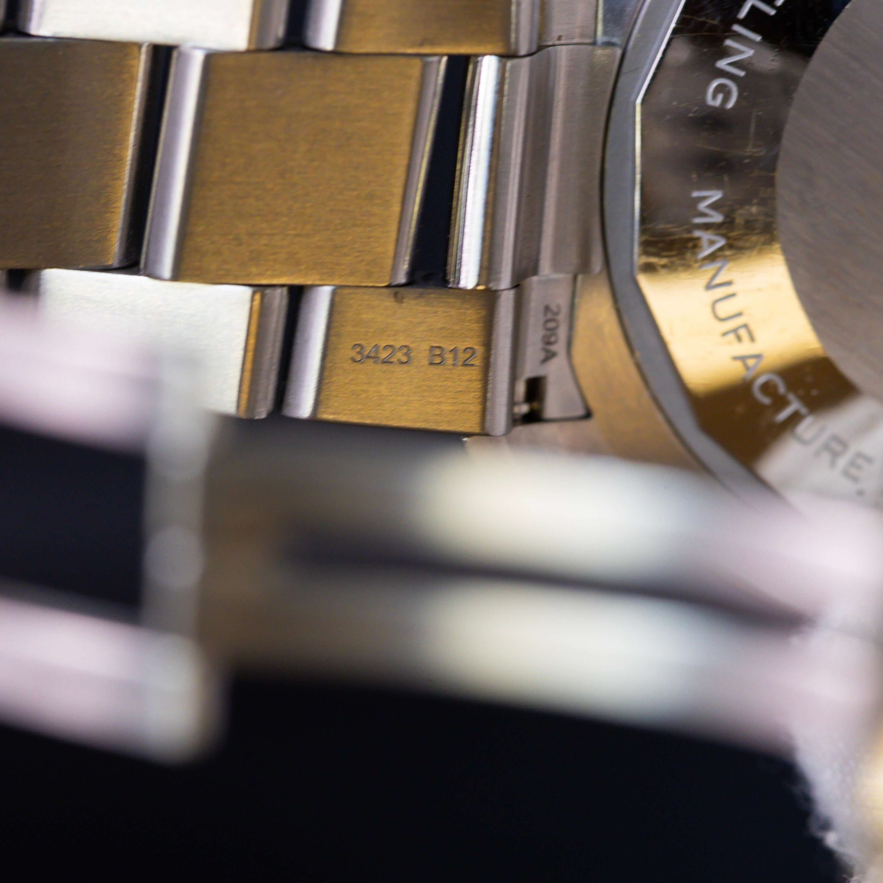 Close-up of Breitling Superocean Automatic 42 watch bracelet showing detailed markings and craftsmanship.