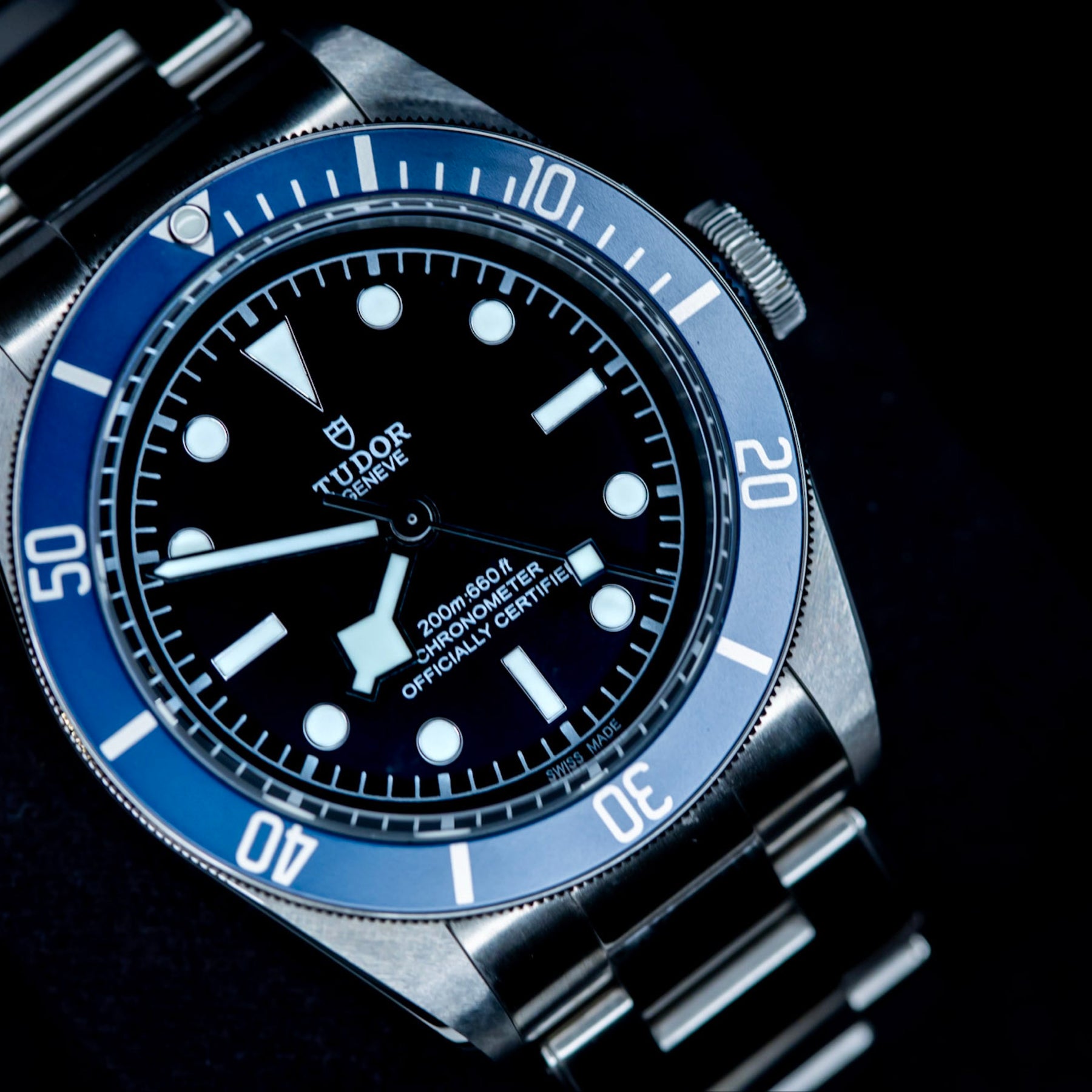 Tudor Black Bay Heritage 79230B luxury watch featuring a blue bezel and black dial.
