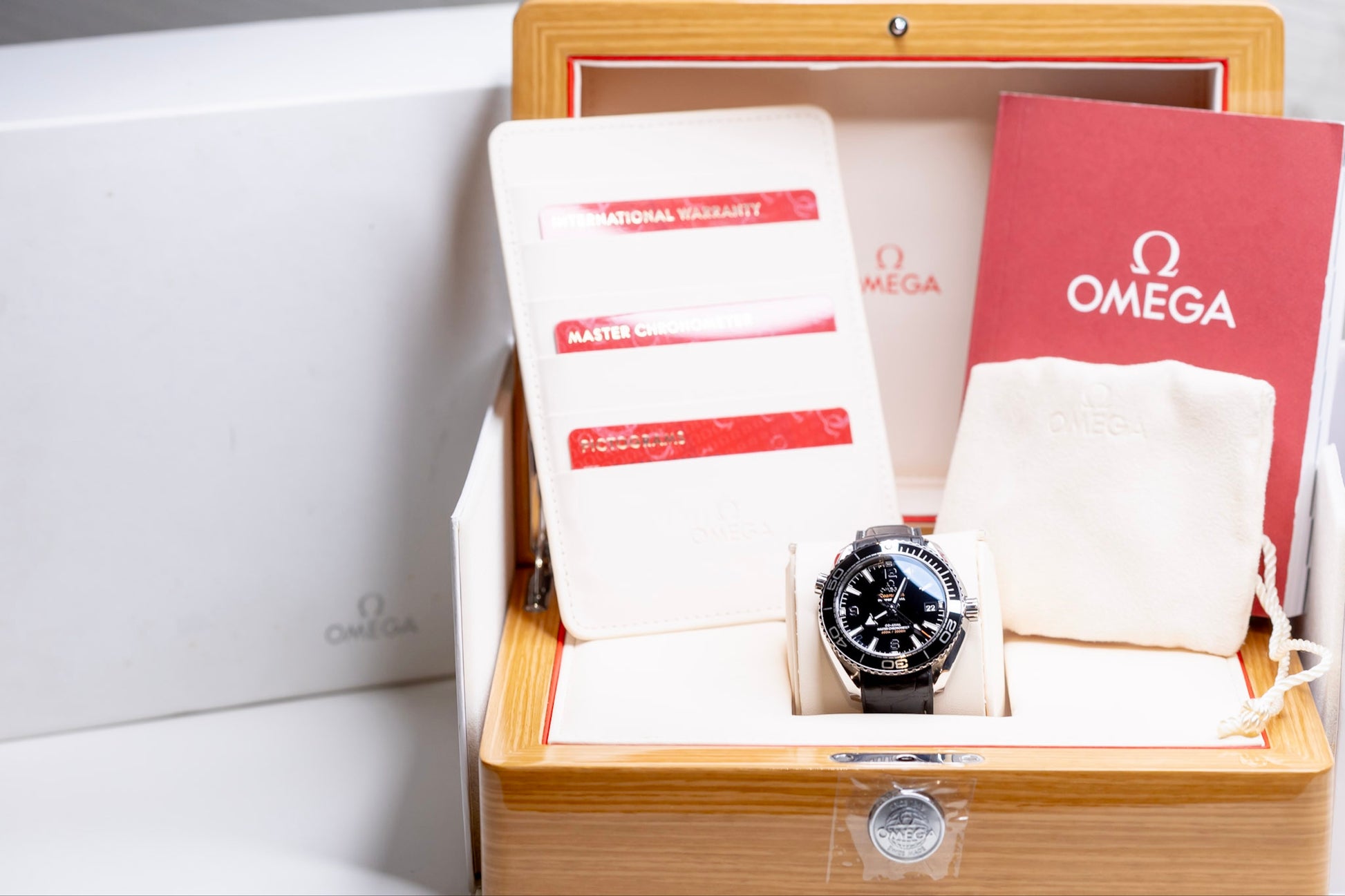 2023 Omega Seamaster Planet Ocean full set in original box with papers and accessories.