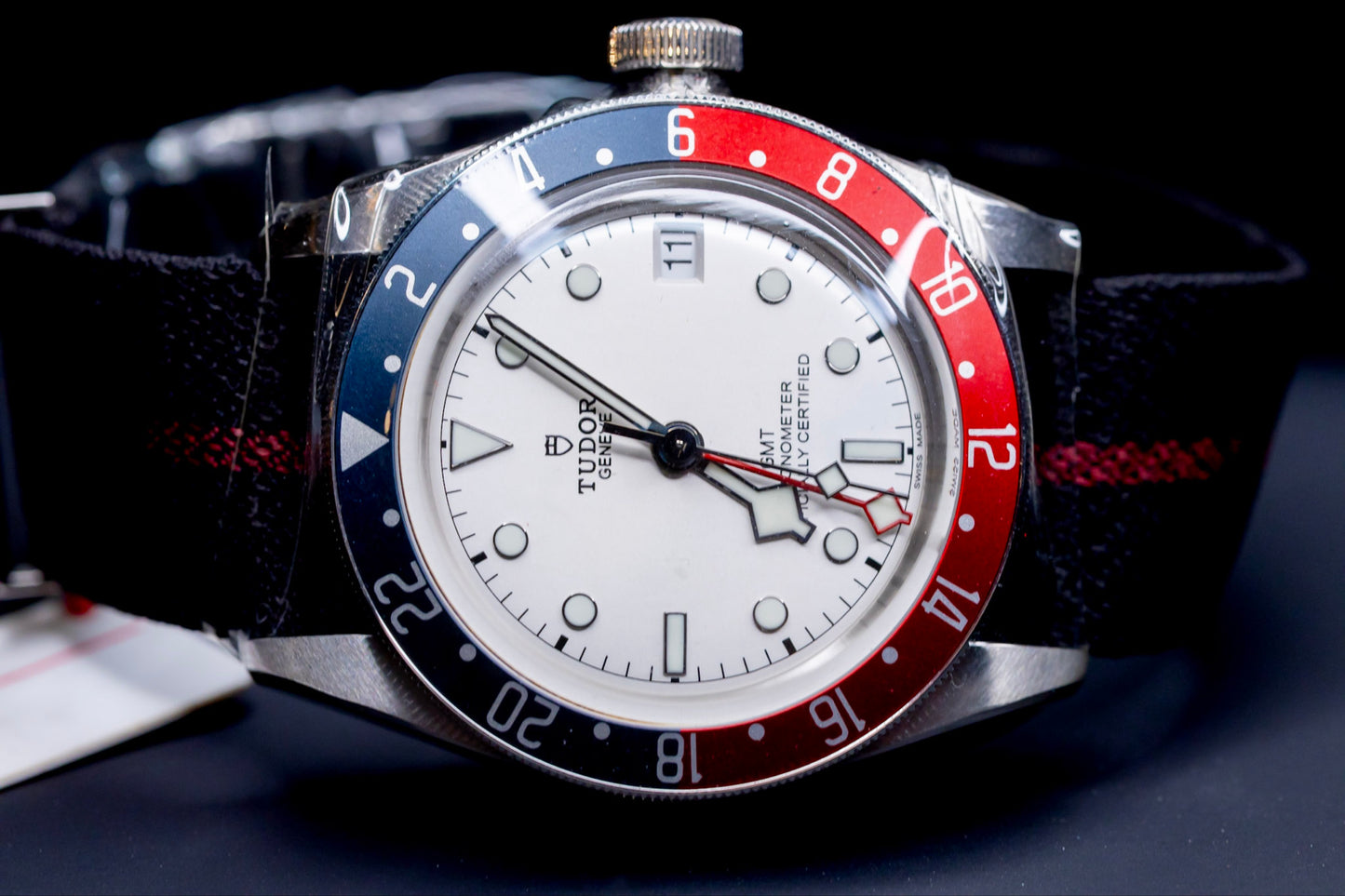 Tudor Black Bay GMT Pepsi watch featuring a white dial and burgundy-and-blue bezel.