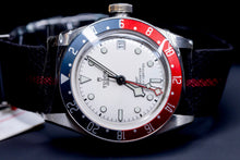 Tudor Black Bay GMT Pepsi watch featuring a white dial and burgundy-and-blue bezel.