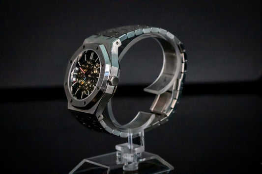 Angled shot of Seiko Mod Oak Skeleton Silver highlighting open-heart design and brushed finish