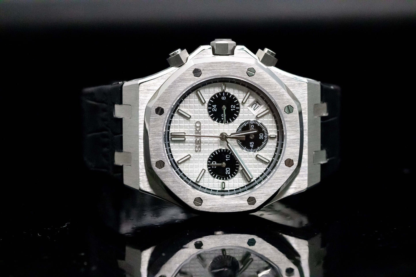 Seiko Mod Royal Oak Chrono Panda watch with silver dial, black leather strap, displaying chronograph features.