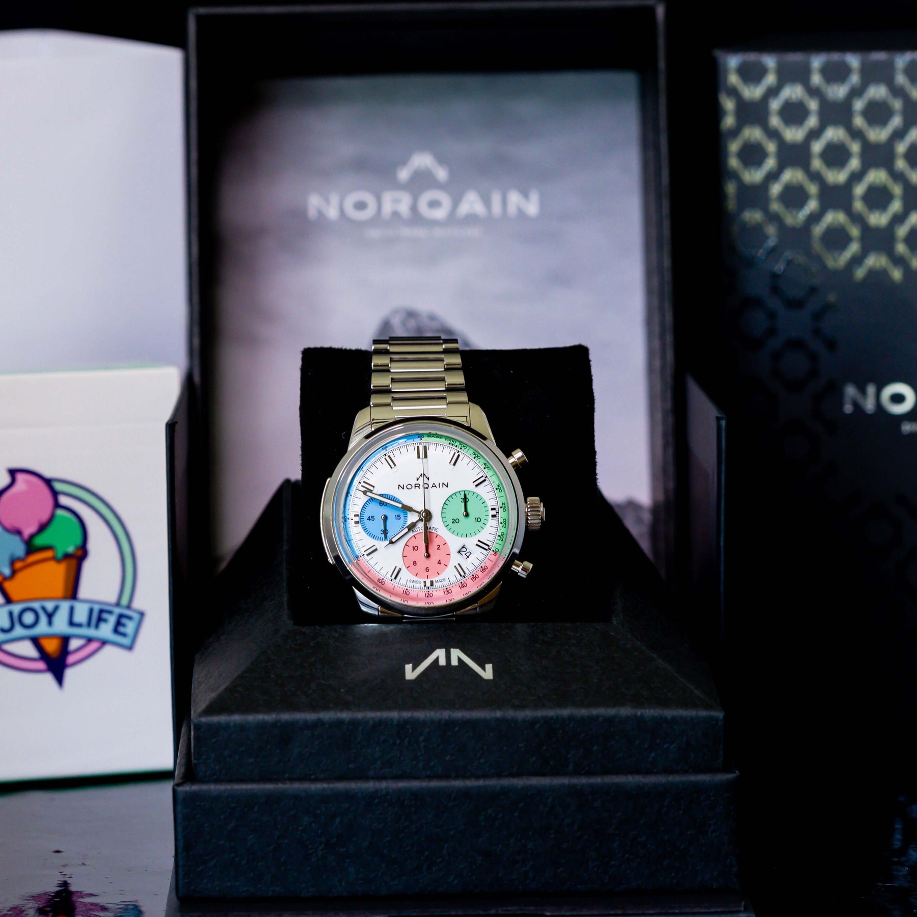Norqain Freedom 60 Chrono Ice Cream Limited Edition showcased in box with Enjoy Life branding.