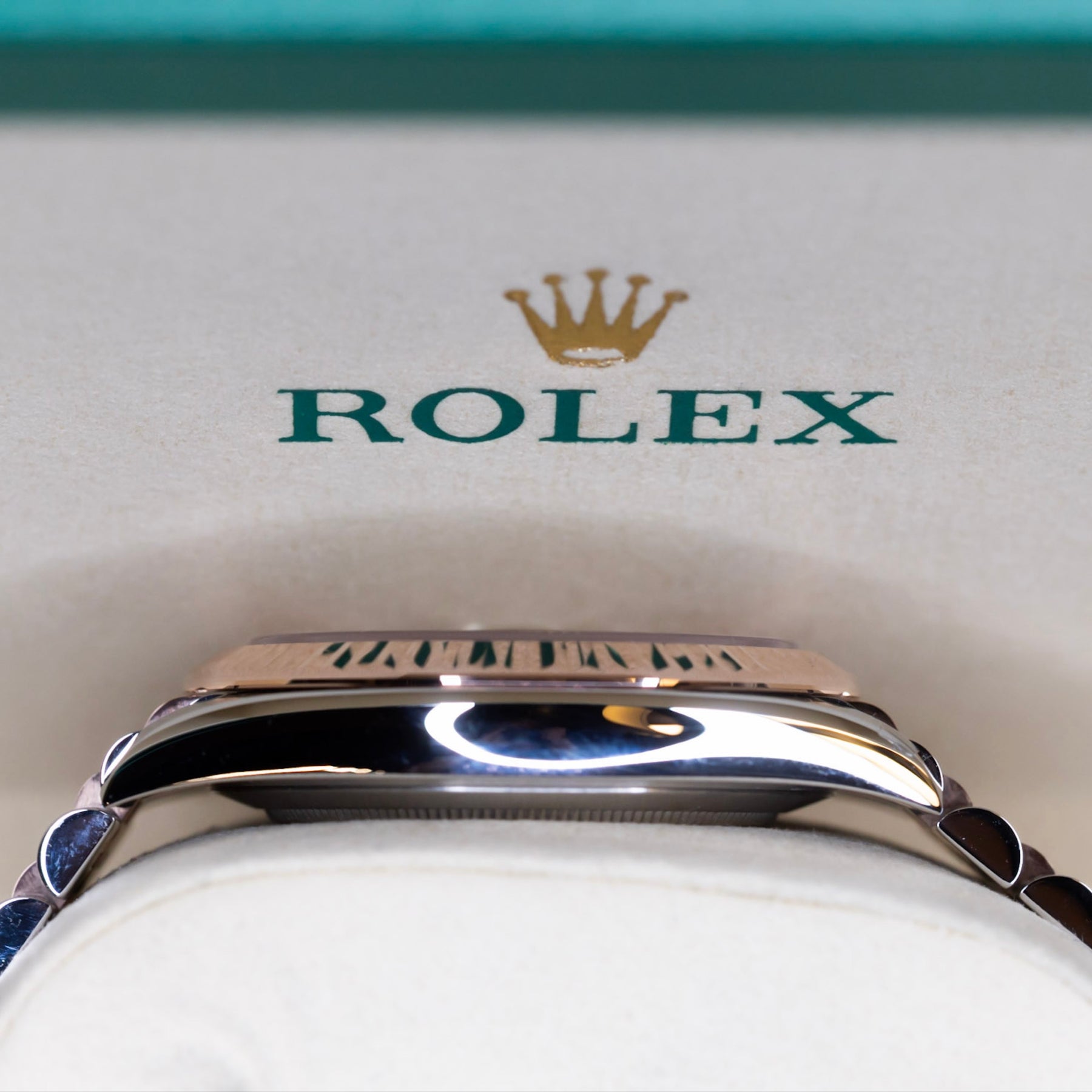 2025 Rolex Datejust 41 rose gold watch displayed with the iconic Rolex logo and crown in background.