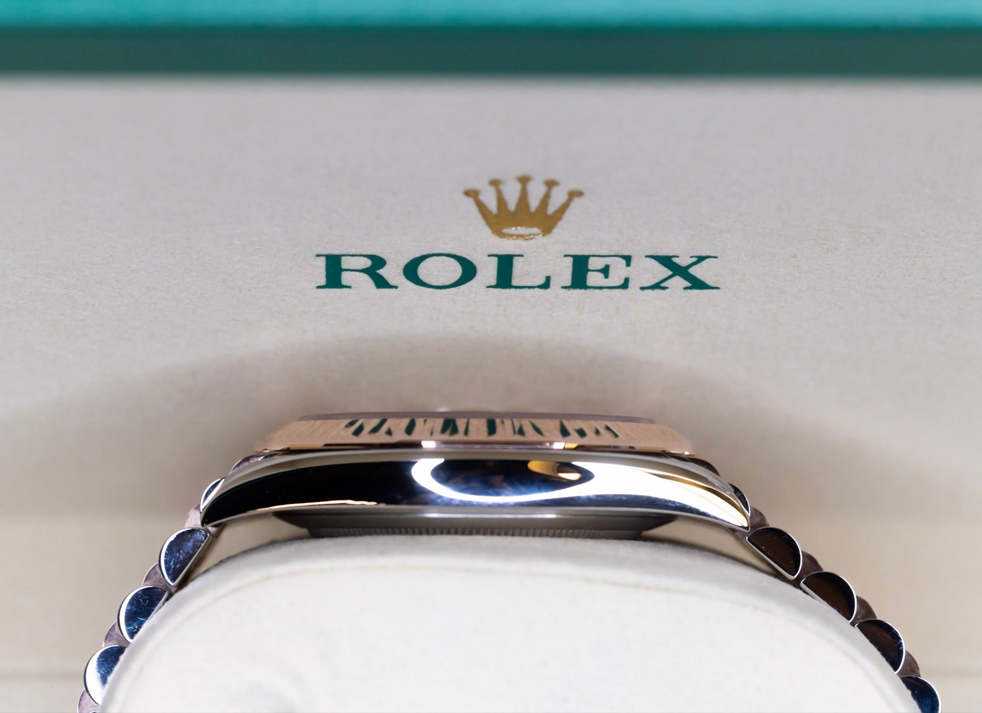 2025 Rolex Datejust 41 rose gold watch displayed with the iconic Rolex logo and crown in background.