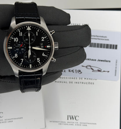 IWC Pilots Watch Chronograph displayed with original box and papers on a gray glove background
