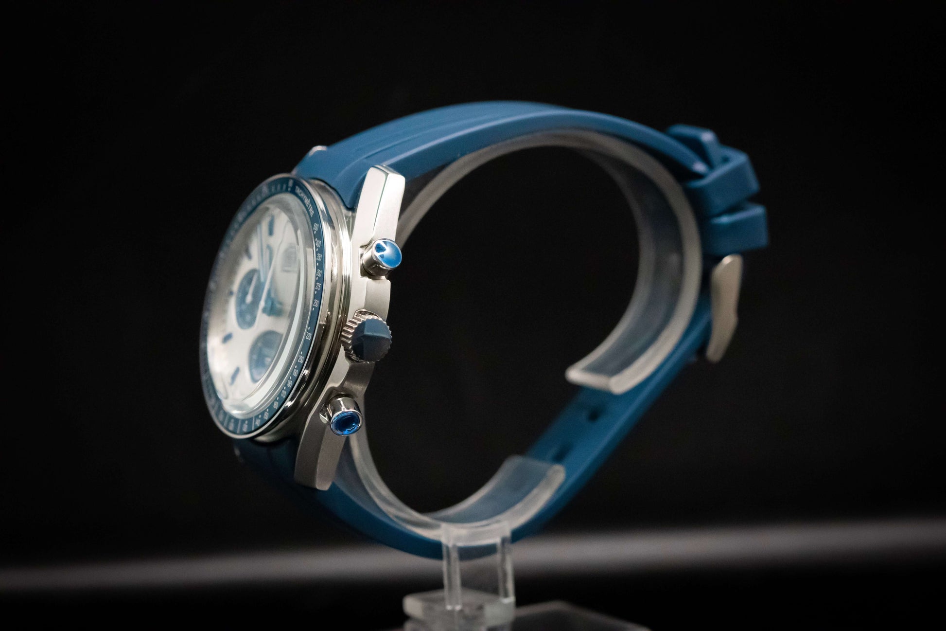 KWC Snoopy Chronograph watch side view, featuring blue rubber strap and stainless steel accents.