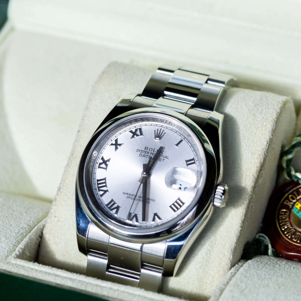 Rolex Datejust 36 full set displayed in a box, featuring a silver dial with Roman indices and Oystersteel case.