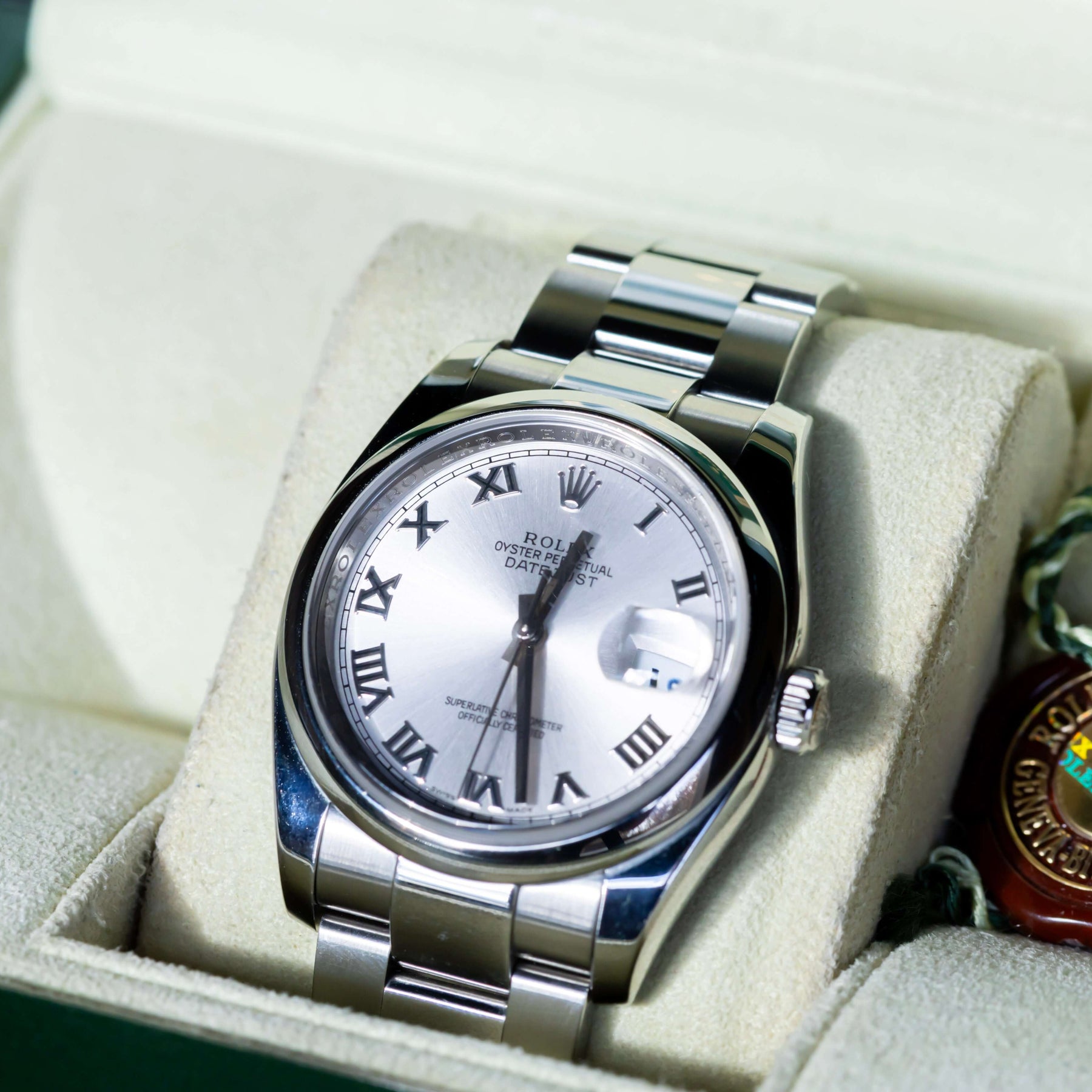 Rolex Datejust 36 full set displayed in a box, featuring a silver dial with Roman indices and Oystersteel case.
