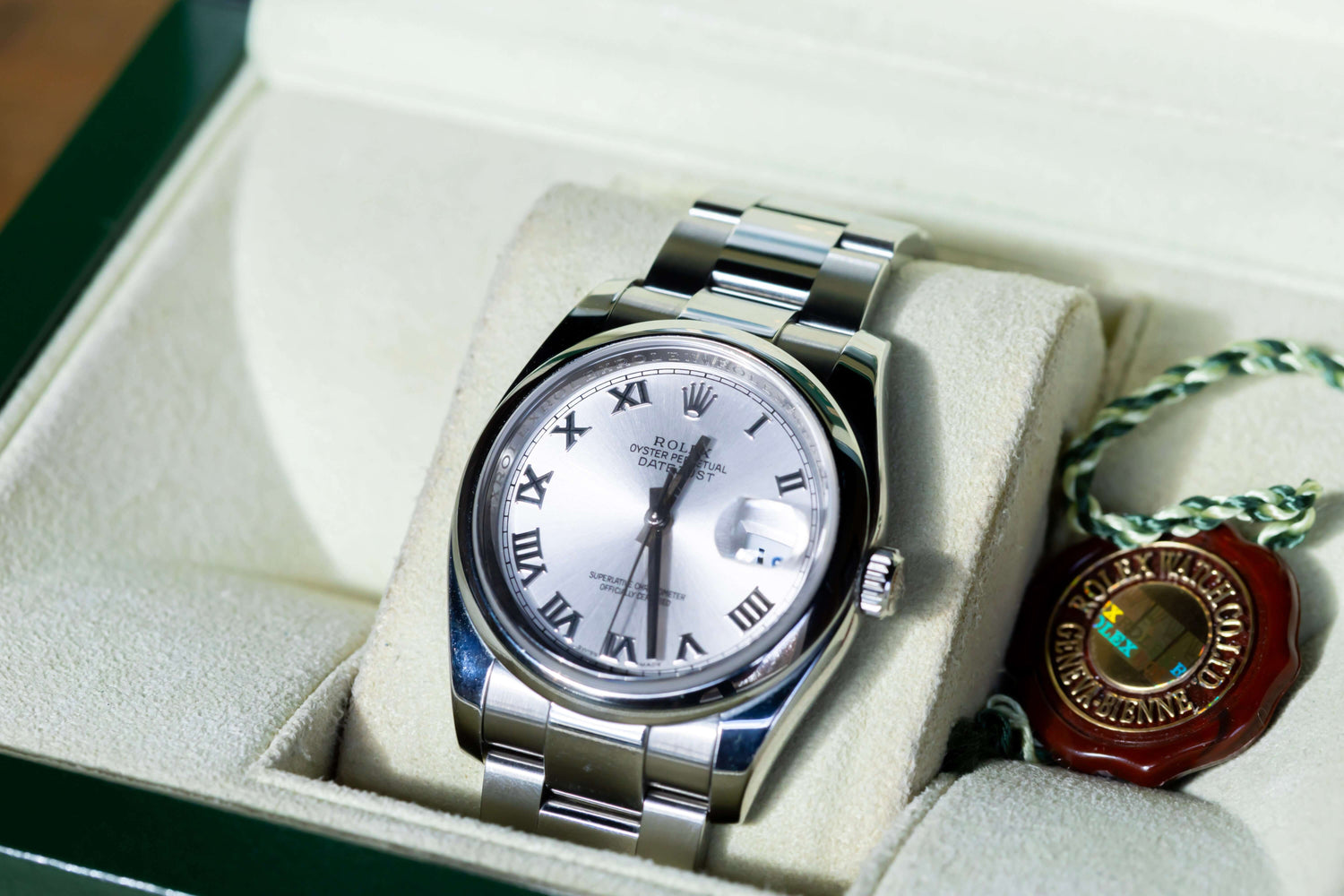 Rolex Datejust 36 full set displayed in a box, featuring a silver dial with Roman indices and Oystersteel case.